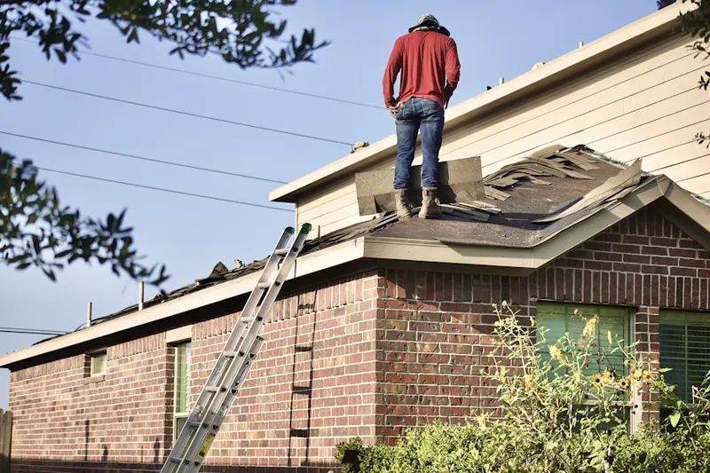 Professional roofer working on a residential roof in West River Plantation